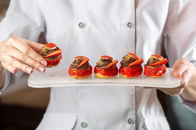 Front view of chef holding a delciious food plate