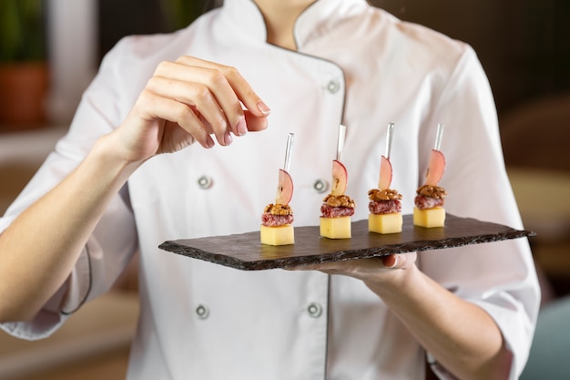 Front view of chef holding a delcious food plate