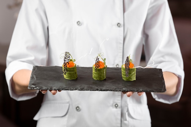 Front view of chef holding a food plate