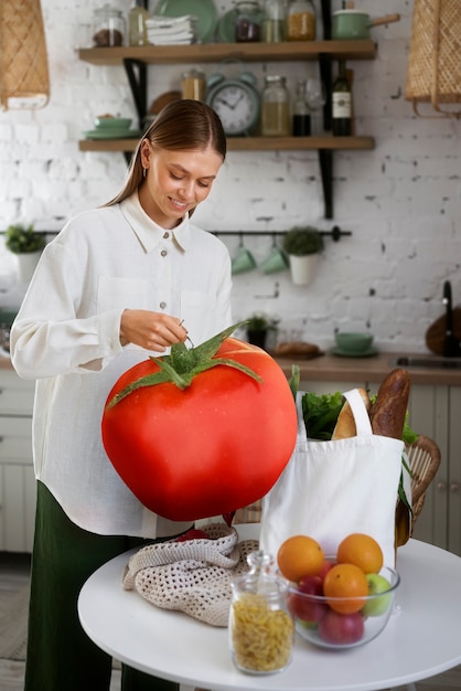 Front view chef holding giant tomato