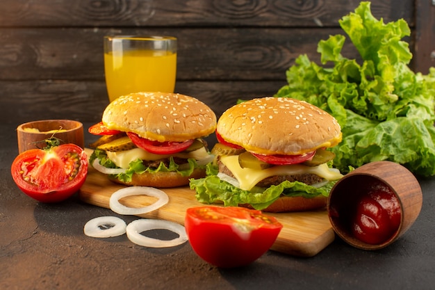 Free photo a front view chicken burger with cheese and green salad on the wooden desk and sandwich fast-food meal