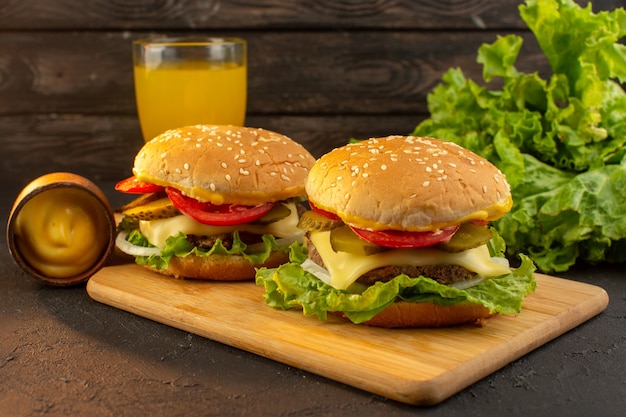 Free Photo a front view chicken burger with cheese juice and green salad on the wooden desk and sandwich fast-food meal