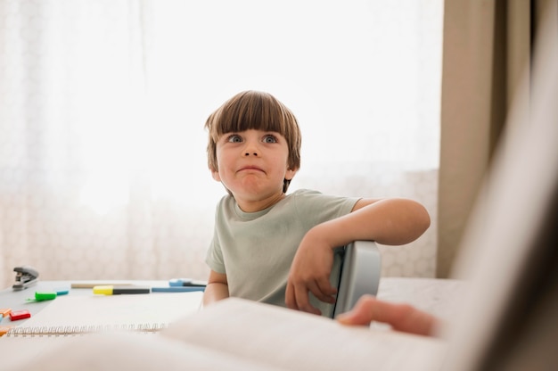 Front view of child being tutored at home