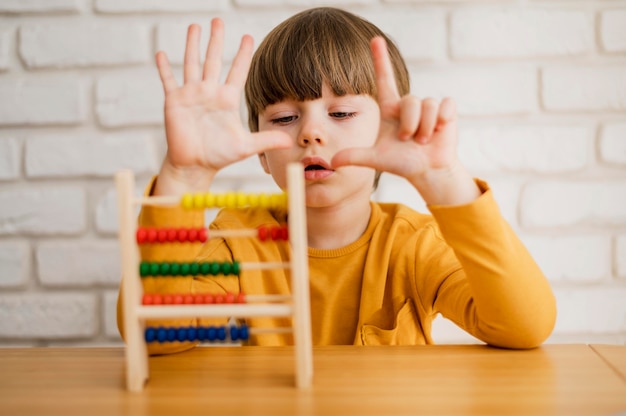 Free photo front view of child using abacus to learn how to count