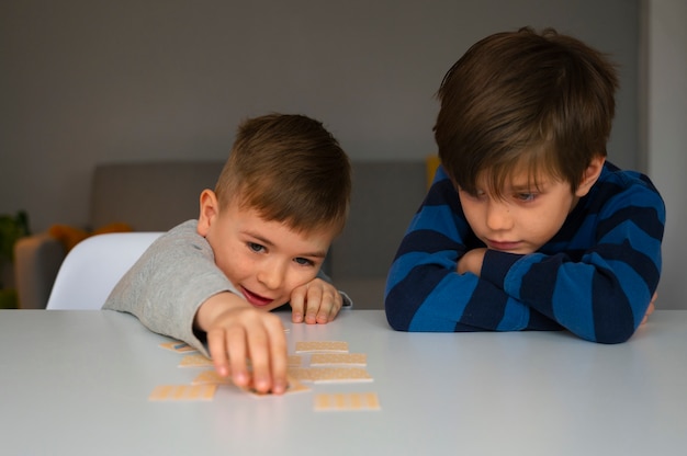 Free Photo front view children playing memory game