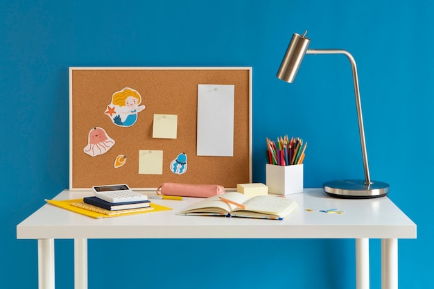 Front view of children's desk with lamp and notebook