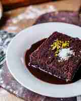 Free photo front view choco cake tasty sweet inside white plate on the brown desk