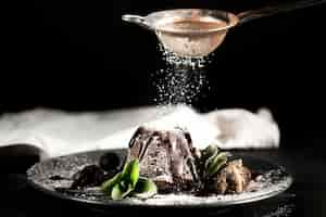 Free photo front view of chocolate cake with powdered sugar