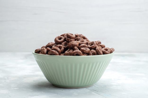 Front view chocolate cereals inside green plate breakfast food meal cacao