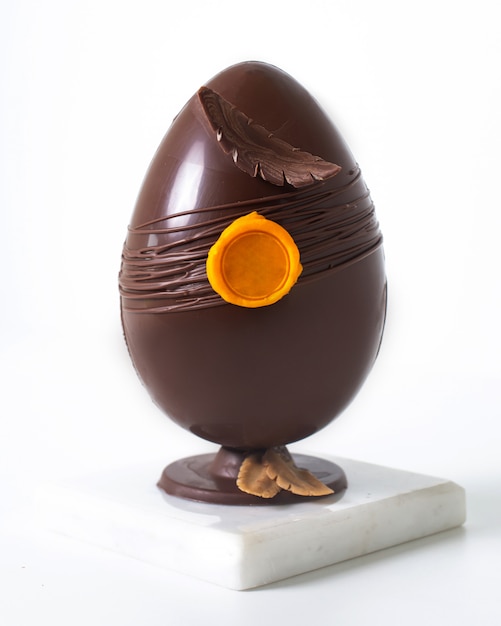 Front view chocolate egg beautiful whole on the white floor