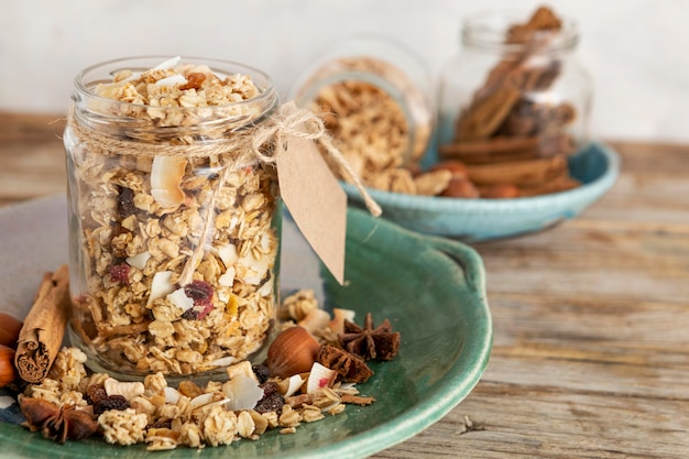 Front view of clear jars on plate with breakfast cereals and tag