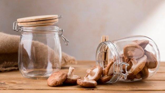 Free Photo front view of clear jars with mushrooms