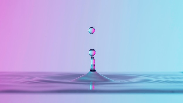 Front view of clear water drops with liquid