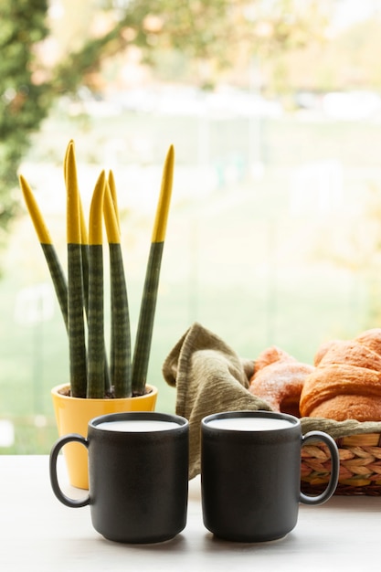 Front view coffee cups with croissants