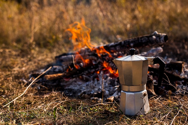 Free Photo front view of coffee grinder and campfire