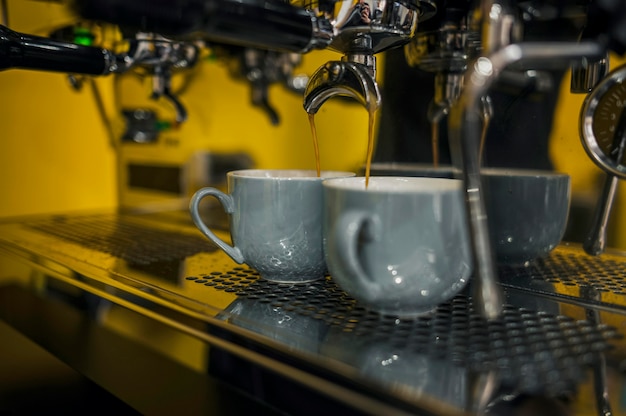 Front view of coffee machine with cups