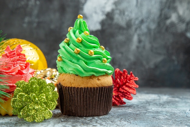 Front view colorful cupcakes xmas ornaments on grey isolated background