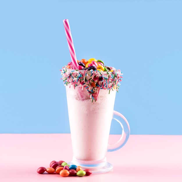 Free photo front view of colorful glass of dessert with straw