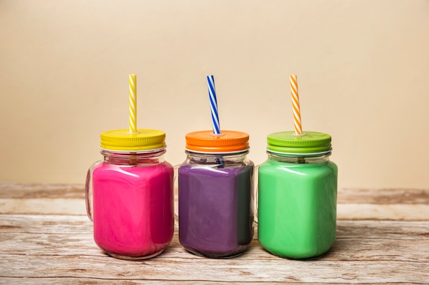 Front view colorful smoothies in jars