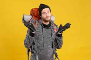 Free photo front view of confused male hitchhiker with leather gloves and red backpack