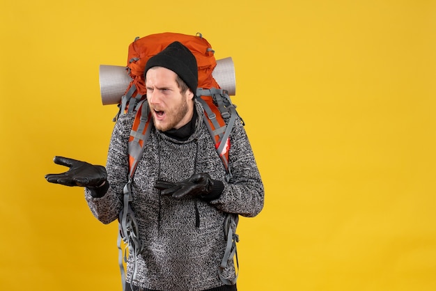 Free photo front view of confused young male with leather gloves and backpack