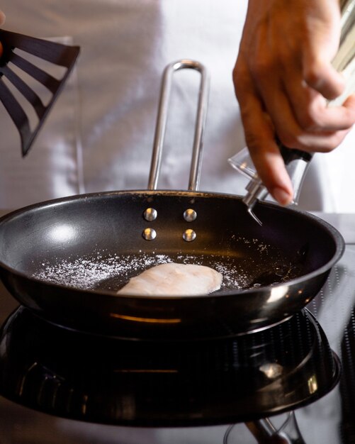 A front view cook frying food in kitchen meal cuisine cook food