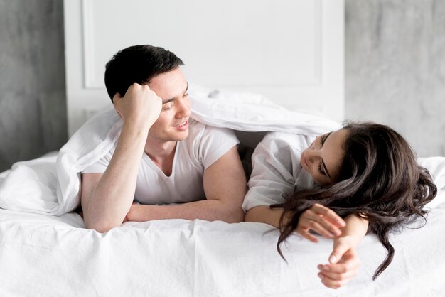 Front view of couple in bed at home