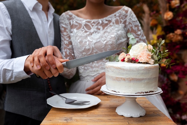 Front view couple cutting cake