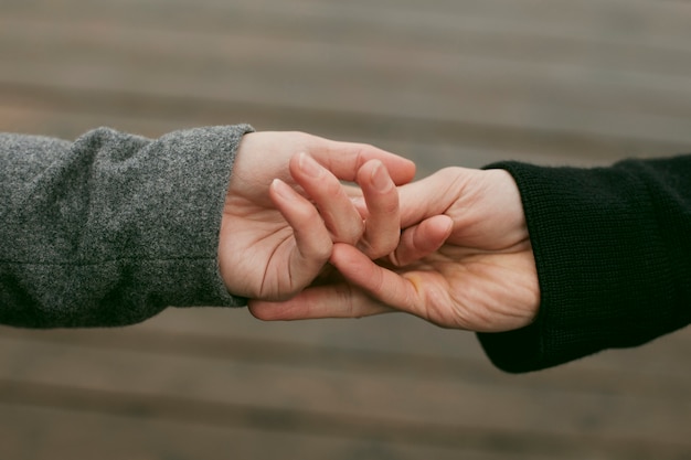 Free photo front view of couple hands concept