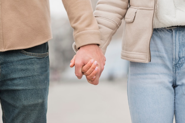 Free photo front view of couple holding hands