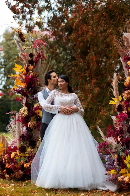 Front view couple posing at wedding