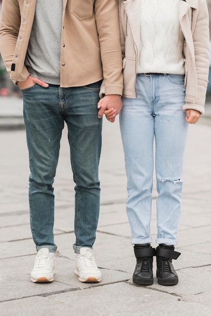 Free photo front view of couple posing while holding hands