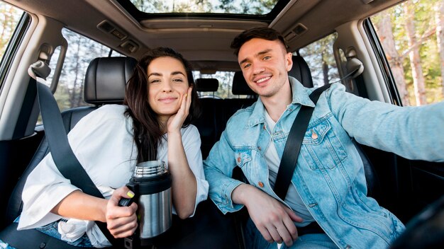 Front view couple taking selfie in car