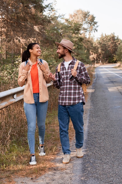 Front view couple taking a walk on the side of the road