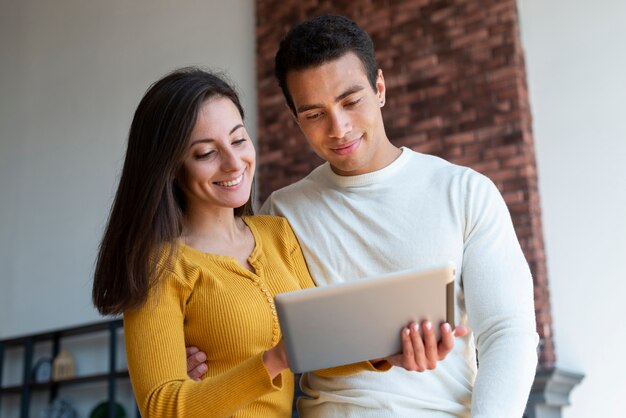 Front view of couple using tablet