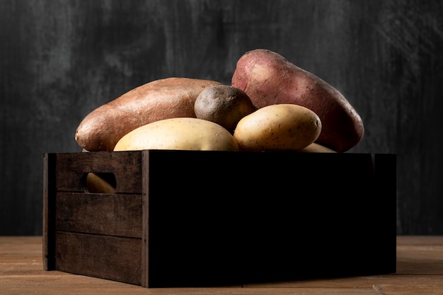 Free photo front view of crate with potatoes