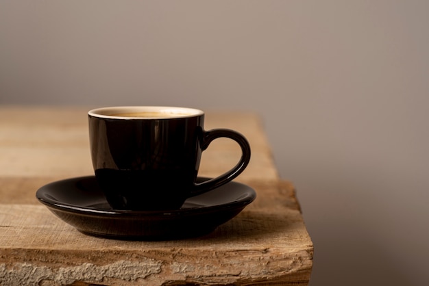 Front view cup of coffee on wooden table