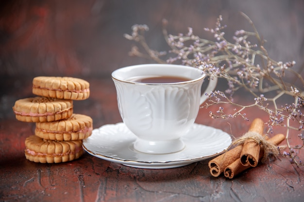 Free Photo front view cup of tea with cookies on dark background