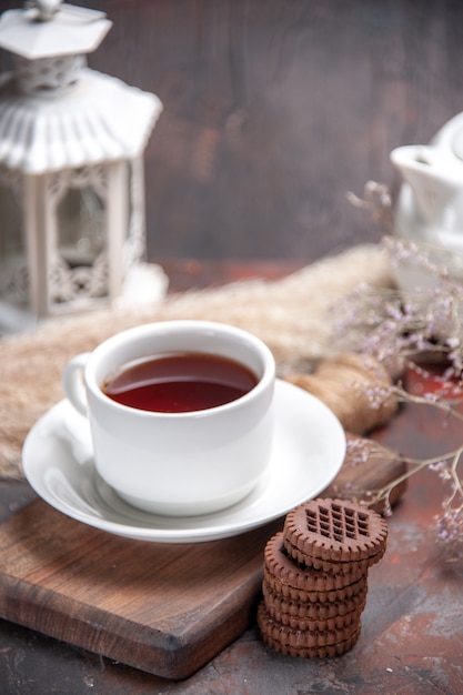 Front view cup of tea with cookies on a dark table  dark biscuit