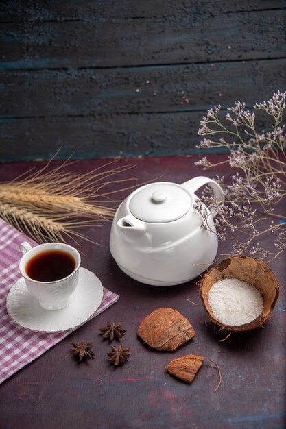 Front view cup of tea with kettle on the dark surface tea drink fruit color