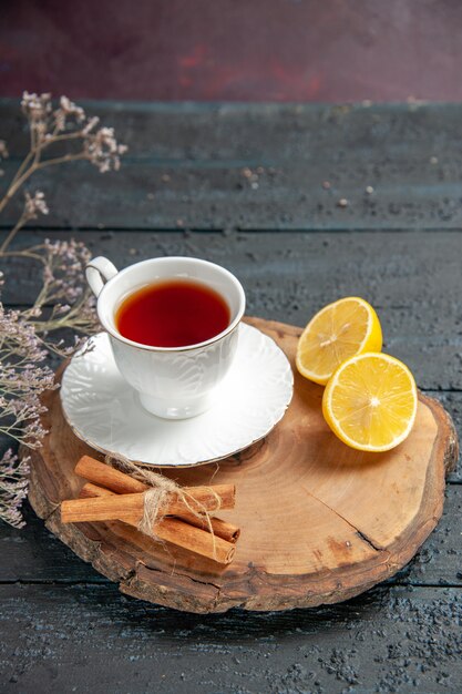 Front view cup of tea with lemon on a dark background