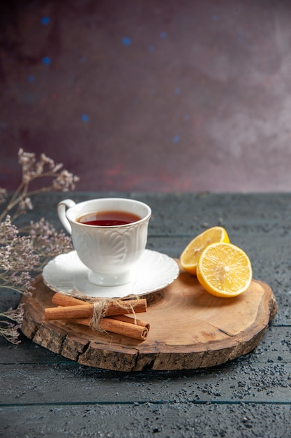 Front view cup of tea with lemon on dark background