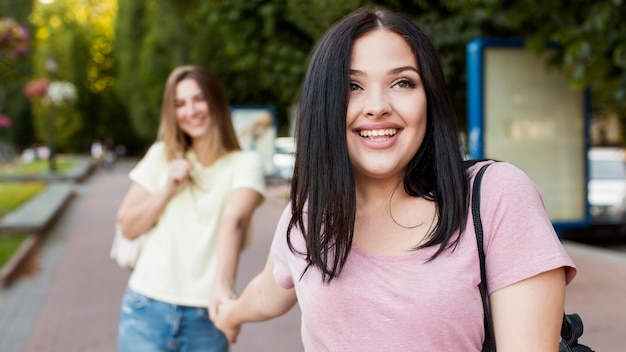 Free Photo front view cute friends holding hands