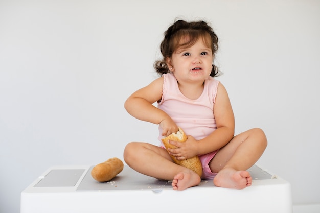 Front view cute girl with bread