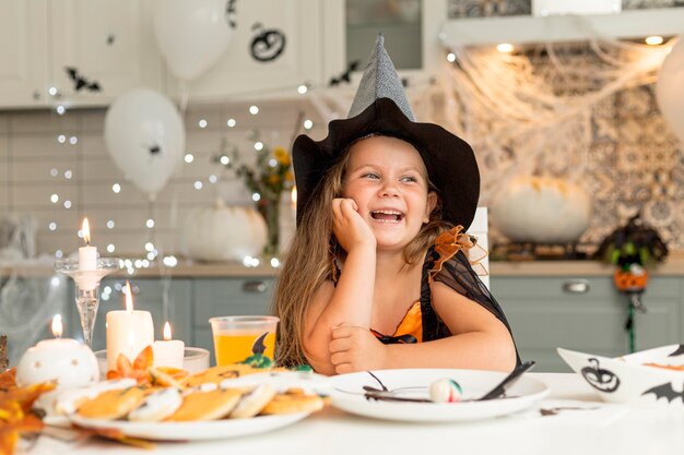 Front view of cute girl with witch costume