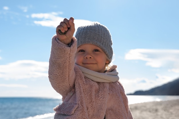 Free photo front view cute kid at seaside