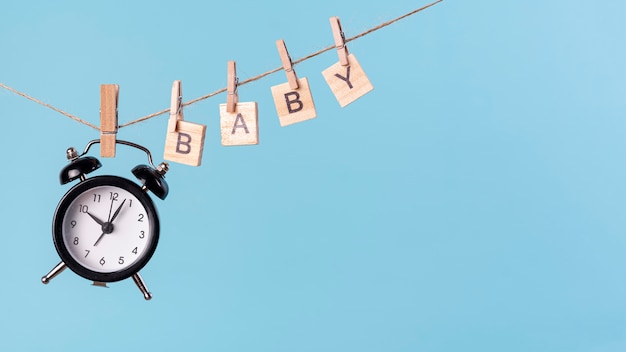 Free photo front view of cute little baby concept with clock