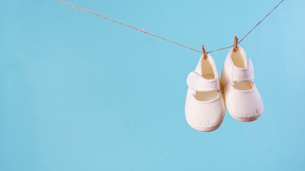 Free photo front view of cute little baby shoes with copy space