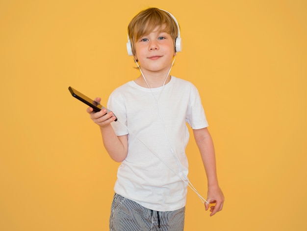 Free Photo front view of cute little boy listening to music