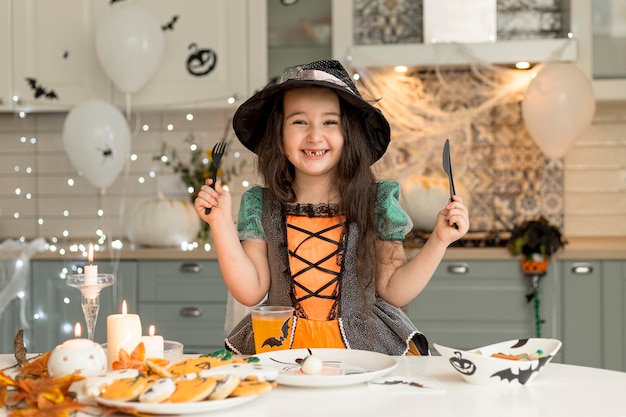 Front view of cute little girl with witch costume